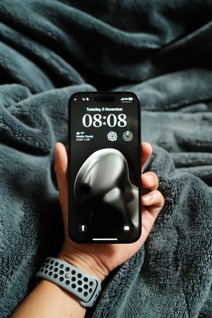 A person holding a cell phone in their hand